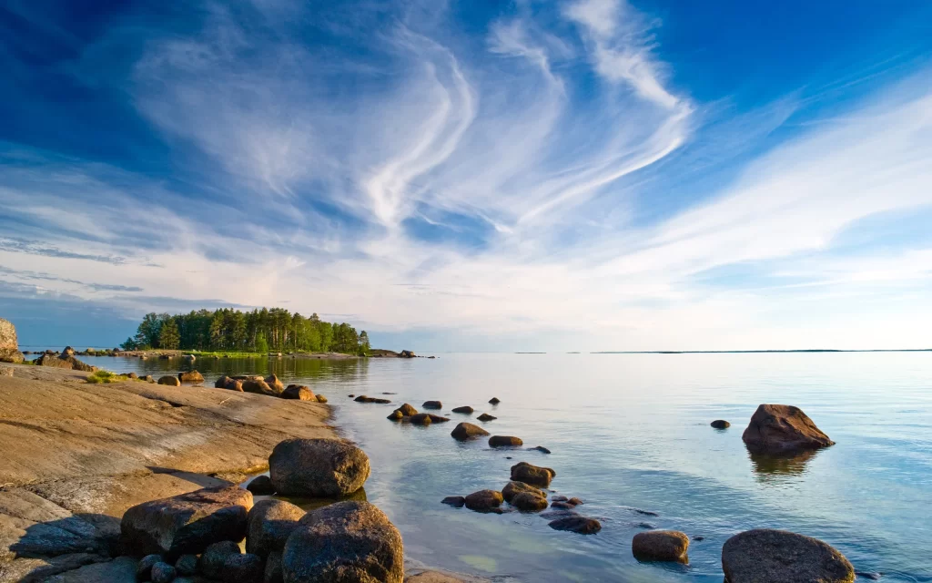 Calm Sea Rocks Shoreline Island Trees Blue Sky Clouds