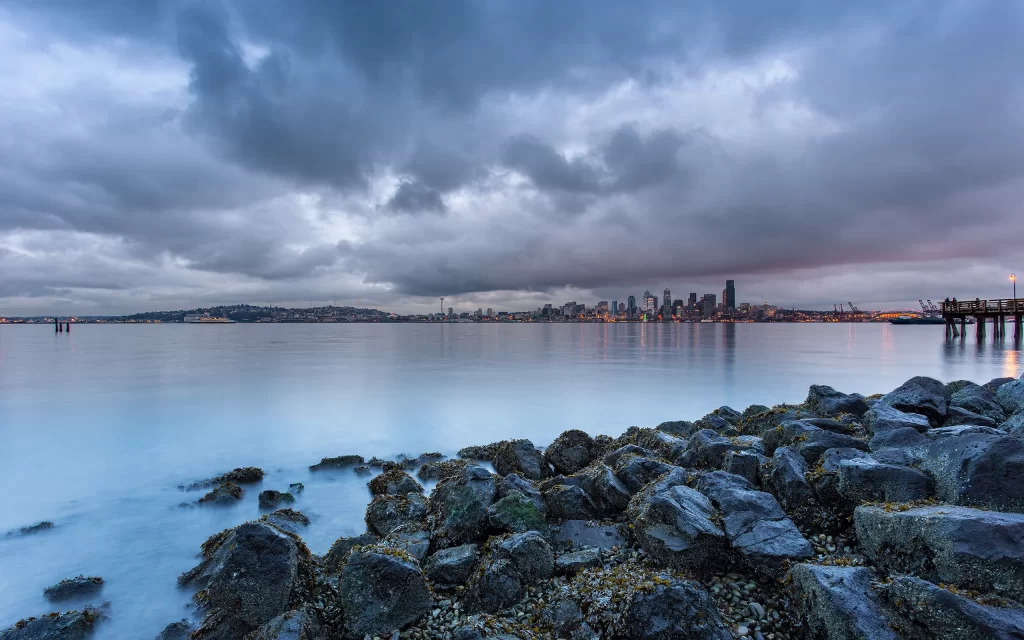 Cityscape Water Rocks Clouds Skyline