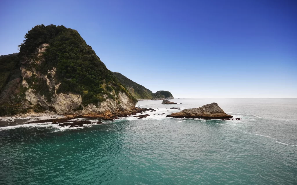 Coastal Cliffs Ocean Waves Rocky Shoreline Clear Sky Greenery