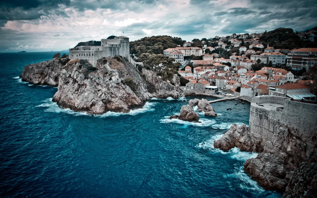 Coastal Town Fortress Rocky Shoreline Mediterranean Sea Cloudy Sky