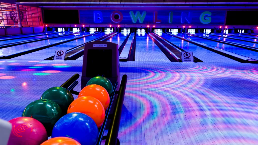 Bowling alley colorful lights bowling balls lanes neon signs entertainment