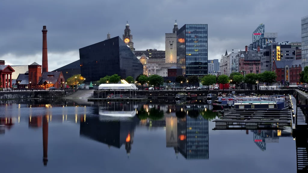 Cityscape waterfront buildings reflection boats evening