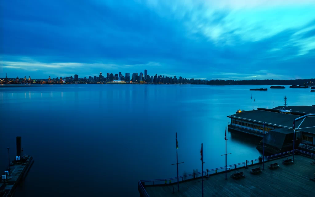 Cityscape waterfront dusk skyline buildings harbor dock lights