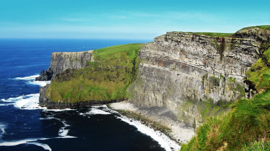 Cliffs ocean green grass blue sky