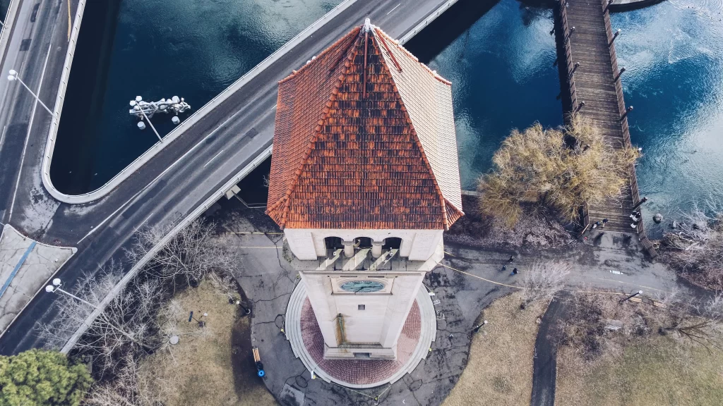Clock Tower Aerial View Red Roof Blue Sky Water Bridge