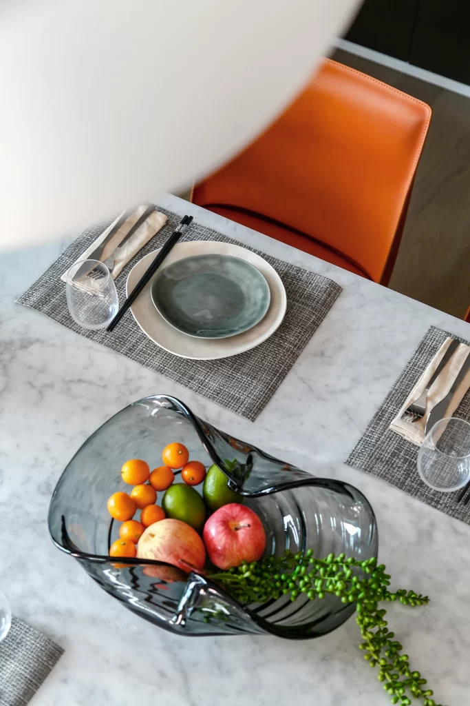 Contemporary Dining Space Marble Table Orange Chair Neutral Tones Modern Design