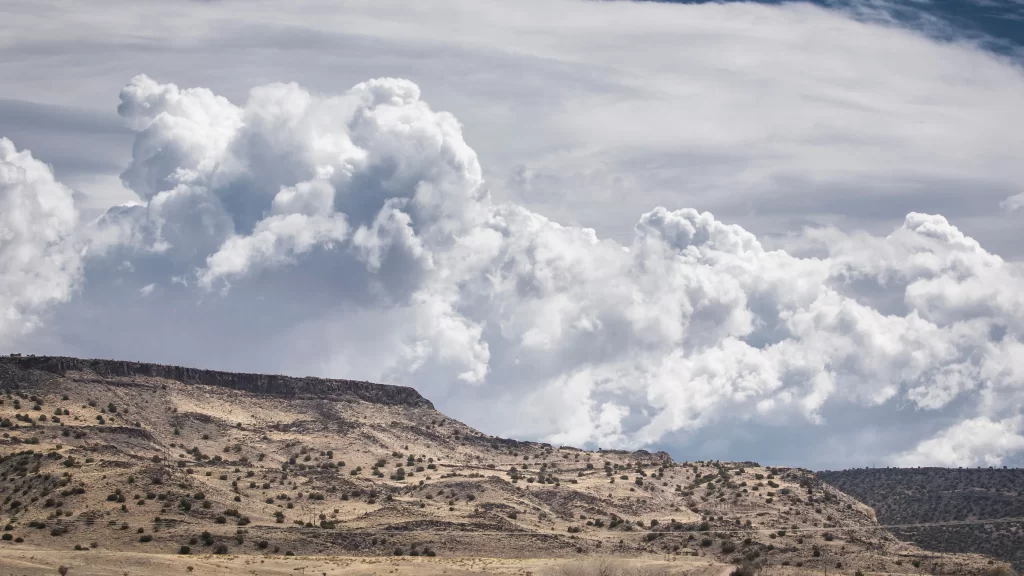 Desert Landscape Clouds Rugged Terrain Sparse Vegetation Dramatic Sky