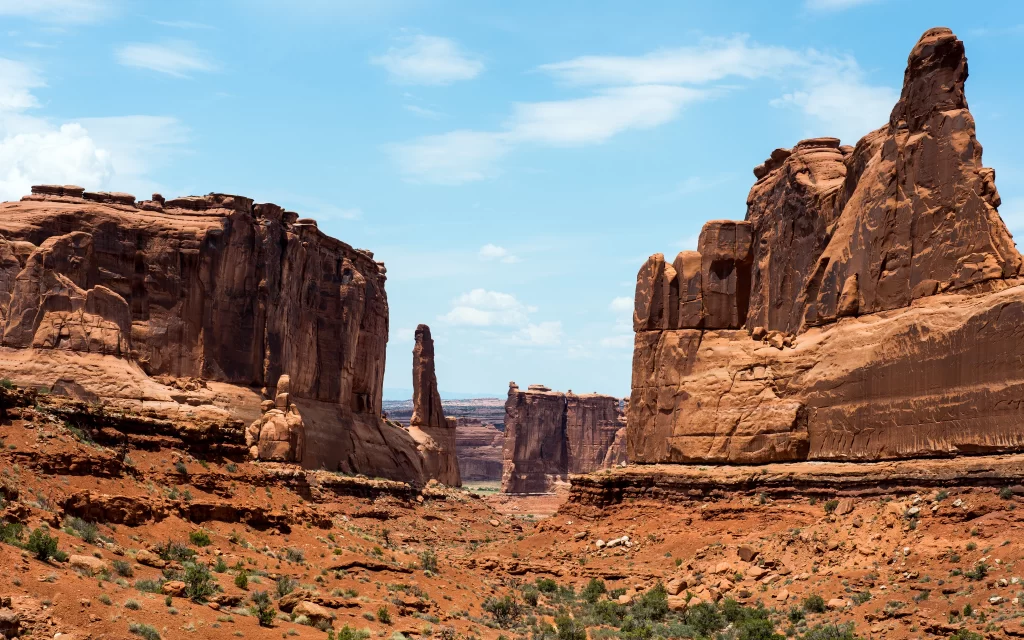 Desert rock formations canyon blue sky sparse vegetation natural landscape