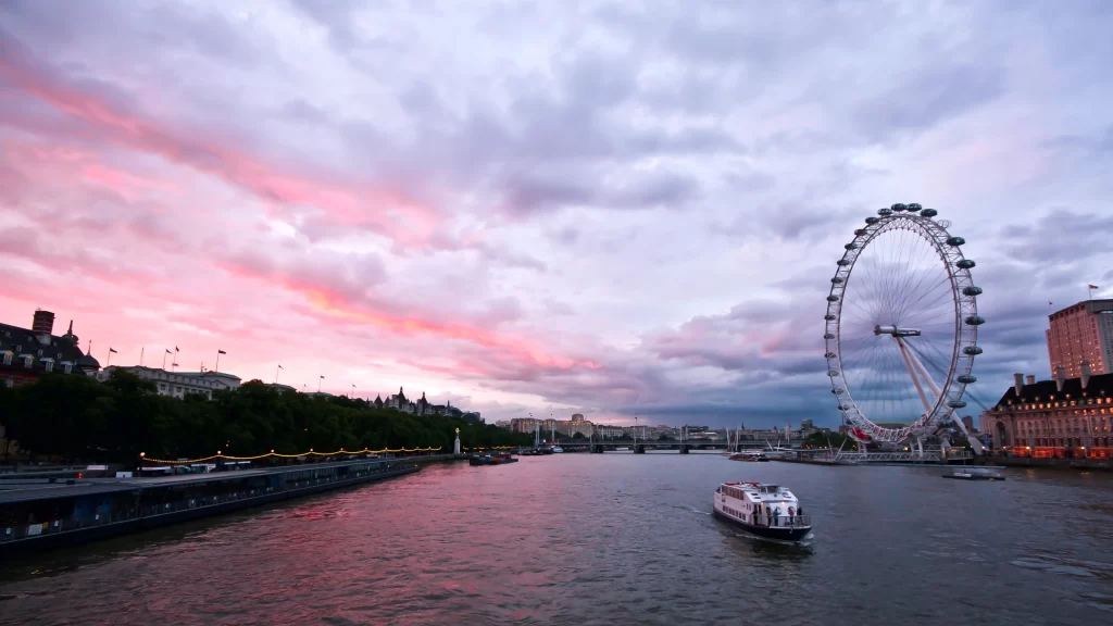 London Eye River Thames sunset clouds boat cityscape