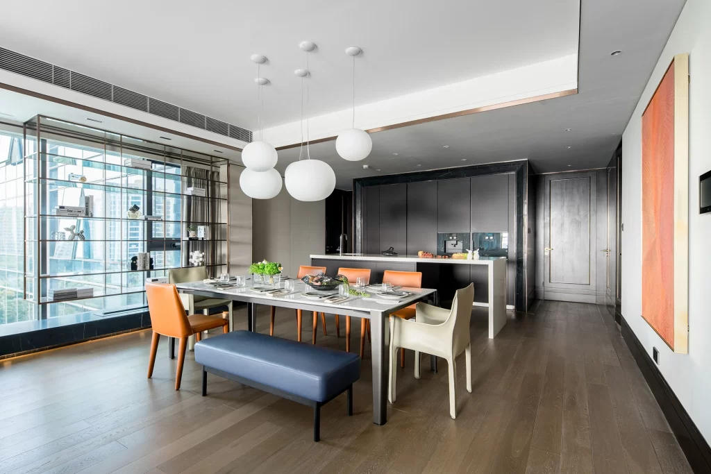 Modern Dining Room Dark Wood Table Orange Chairs White Pendant Lights