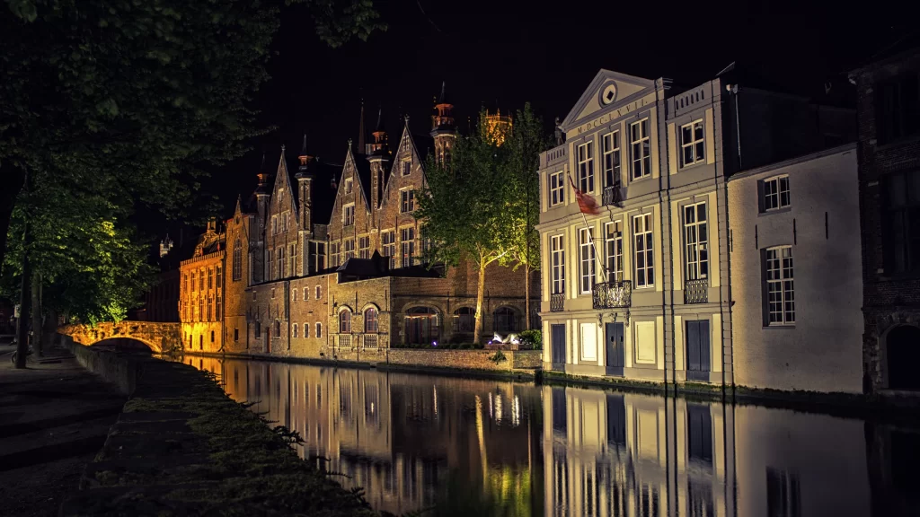 Nighttime canal buildings reflection lights trees