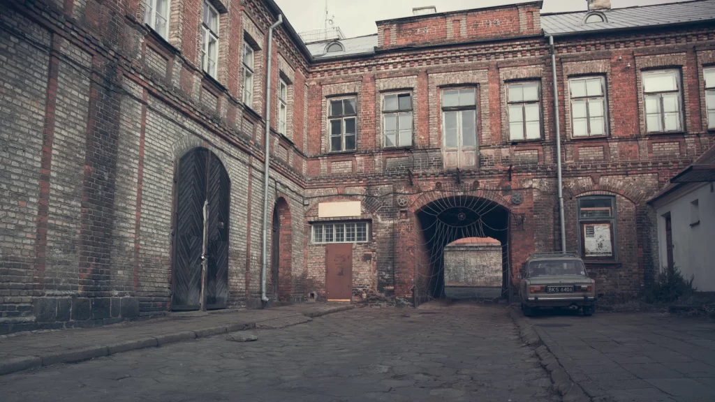 Old building brick archway car windows courtyard