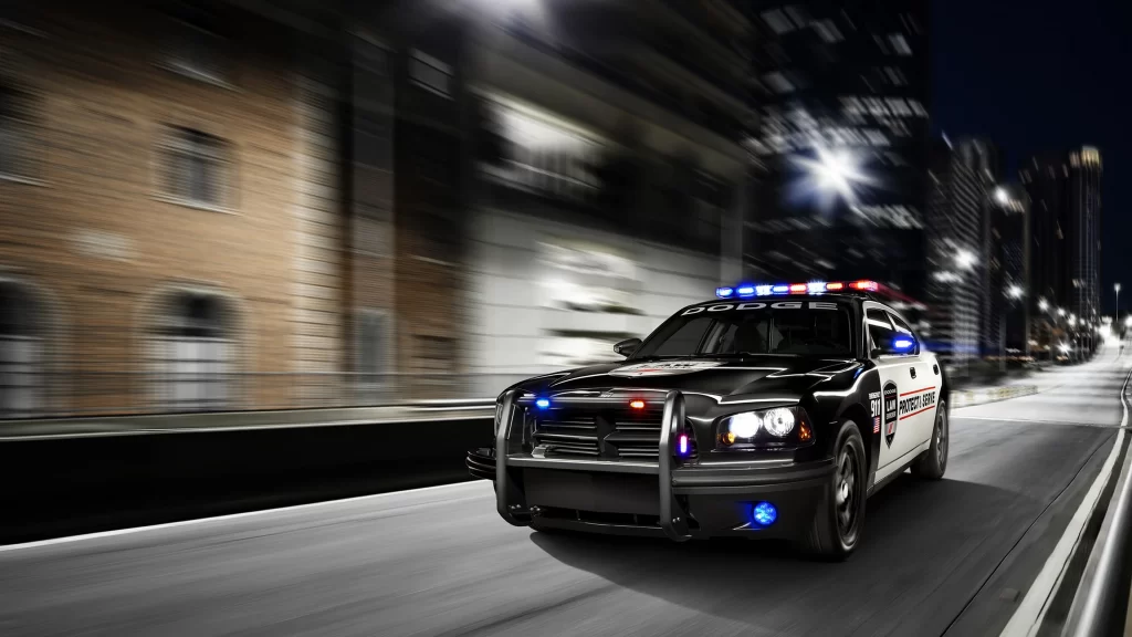 Police car night city street lights motion speed emergency