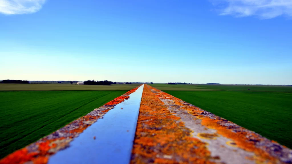 Rust Metal Green Field Blue Sky Horizon Perspective