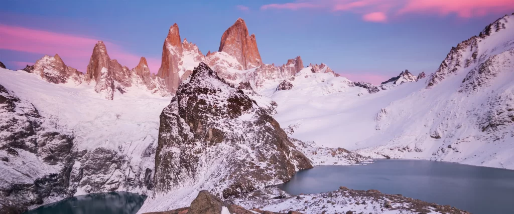 Snowy Mountains Tranquil Lake Pink Sky Rugged Peaks Serene Landscape