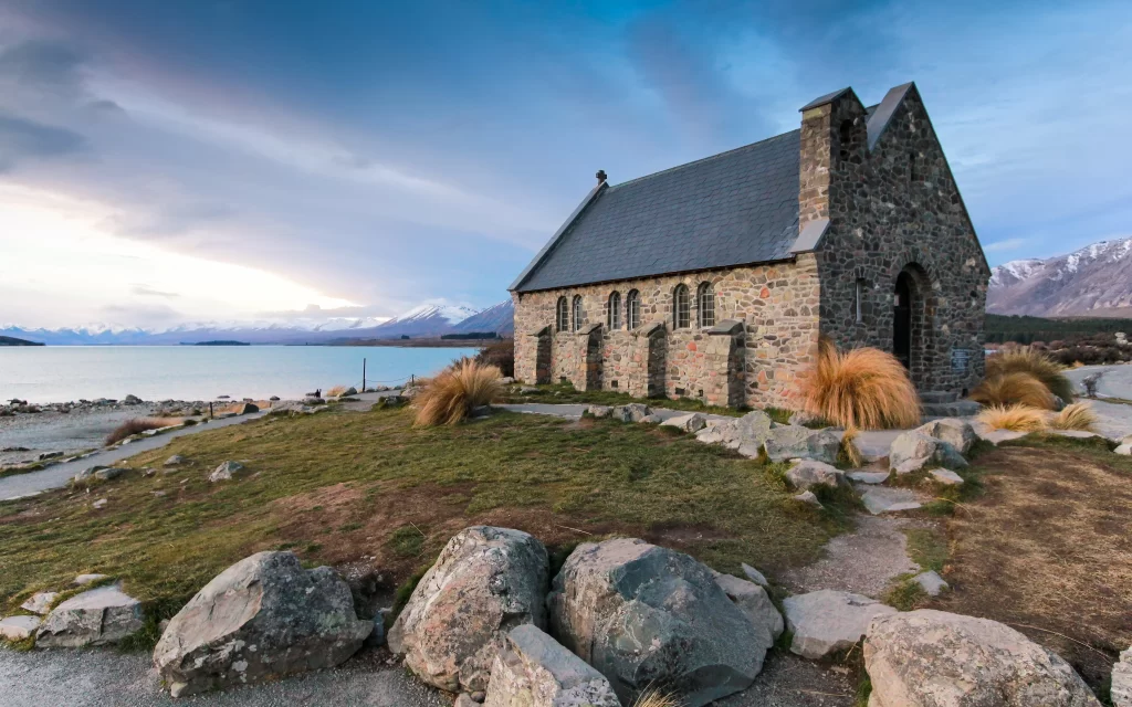 Stone Building Lake Mountains Grass Sky Clouds