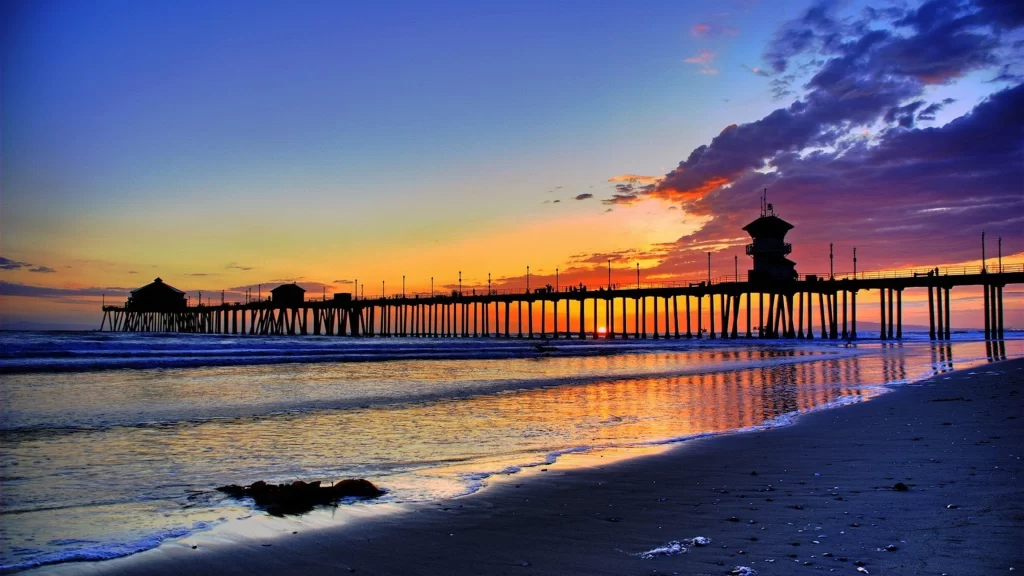 Sunset beach pier ocean sky clouds