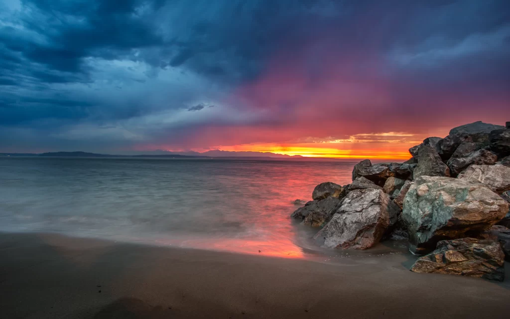 Sunset beach rocks clouds ocean sky