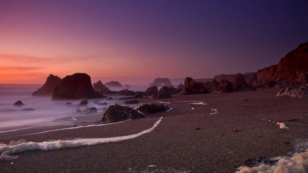 Sunset beach rocks ocean sky waves
