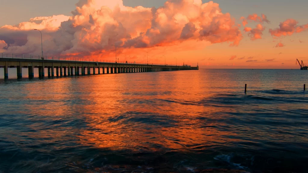 Sunset bridge ocean clouds reflection sky