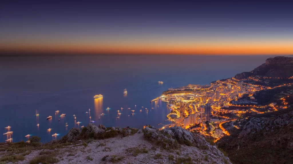 Sunset cityscape ocean boats lights mountains
