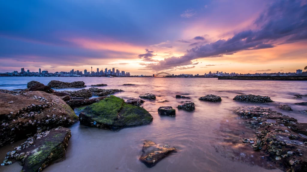 Sunset Cityscape Skyline Water Rocks Clouds
