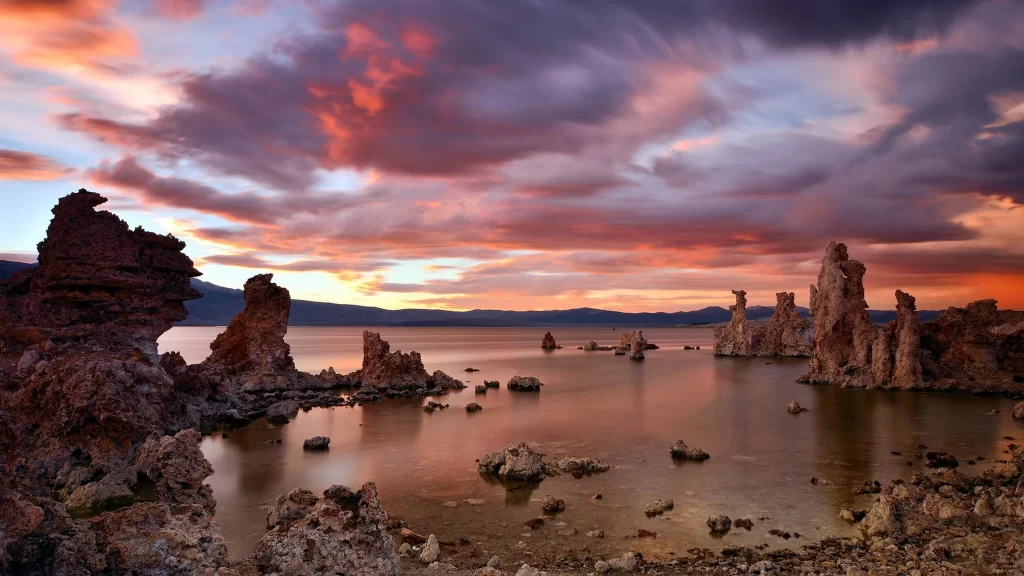 Sunset clouds lake rocks reflection landscape