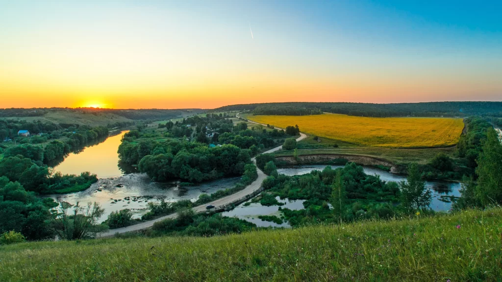 Sunset landscape river trees field sky