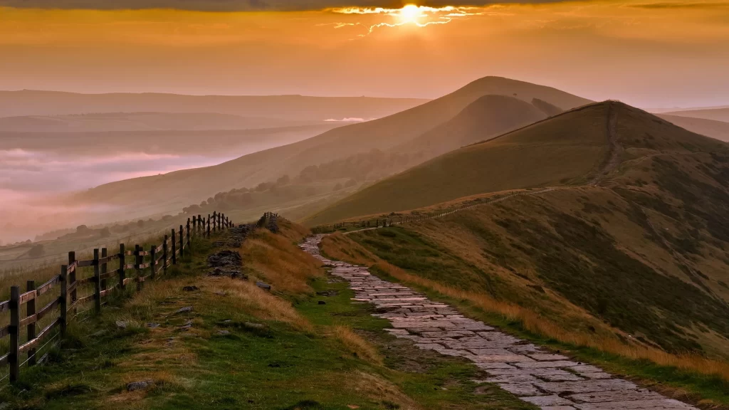 Sunset mountain path fence clouds landscape