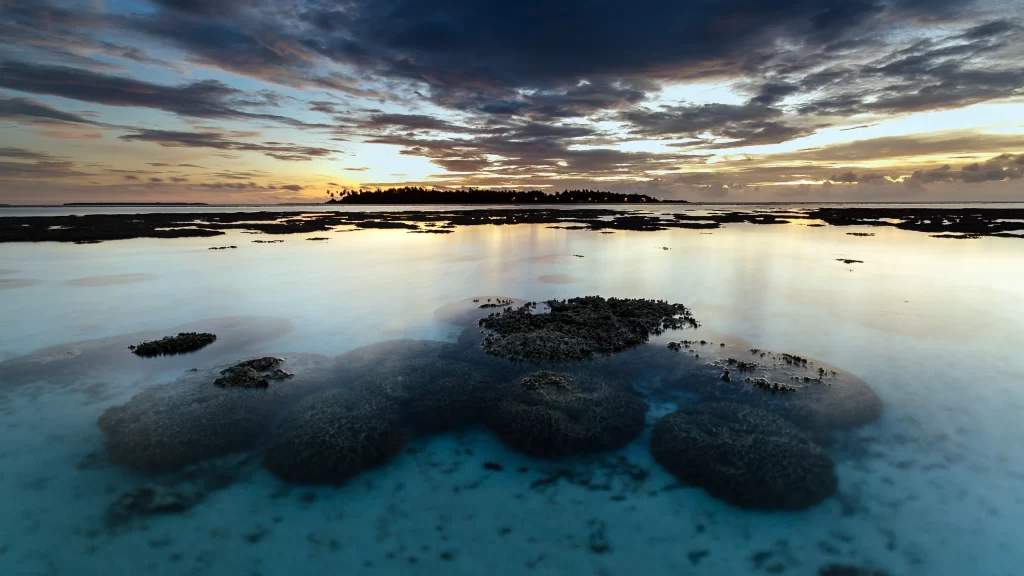 Sunset ocean island clouds water coral