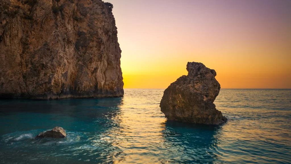 Sunset ocean rock cliff horizon tranquil