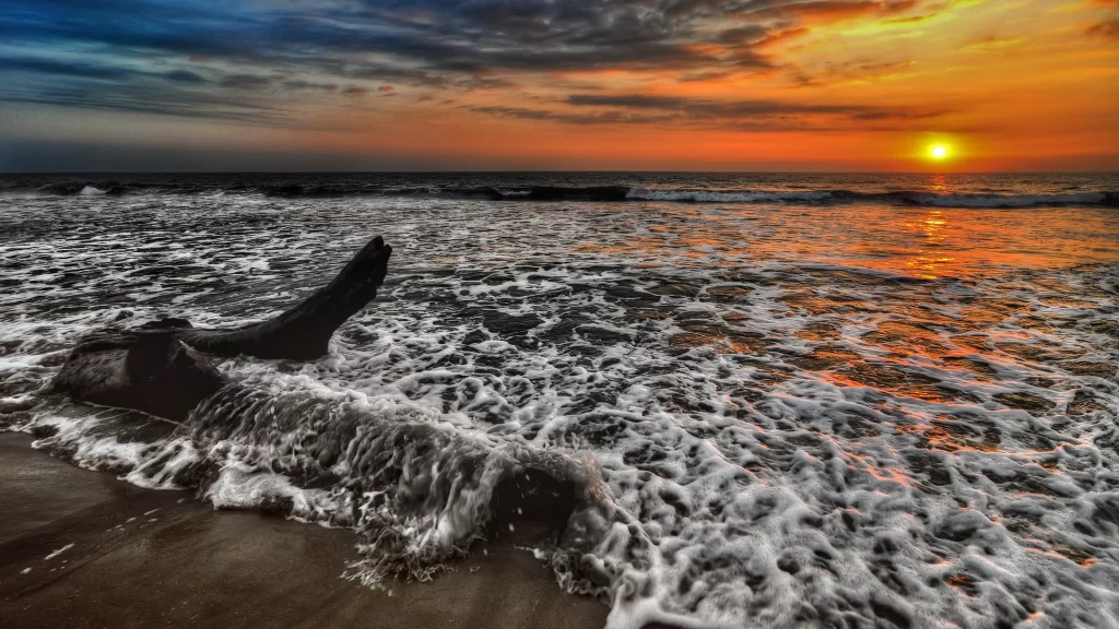 Sunset ocean waves beach sky clouds