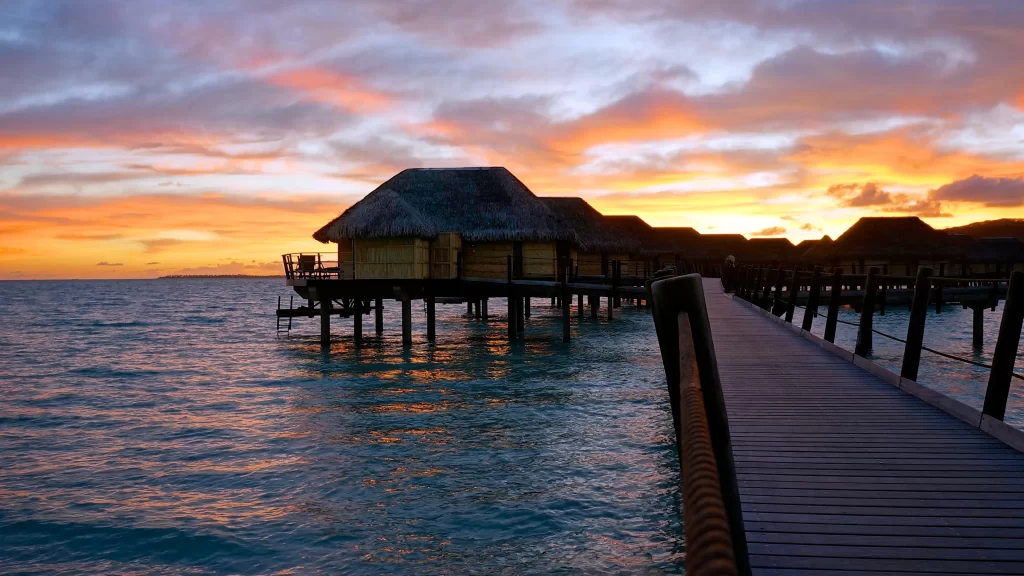 Sunset overwater bungalows ocean wooden walkway tropical serene