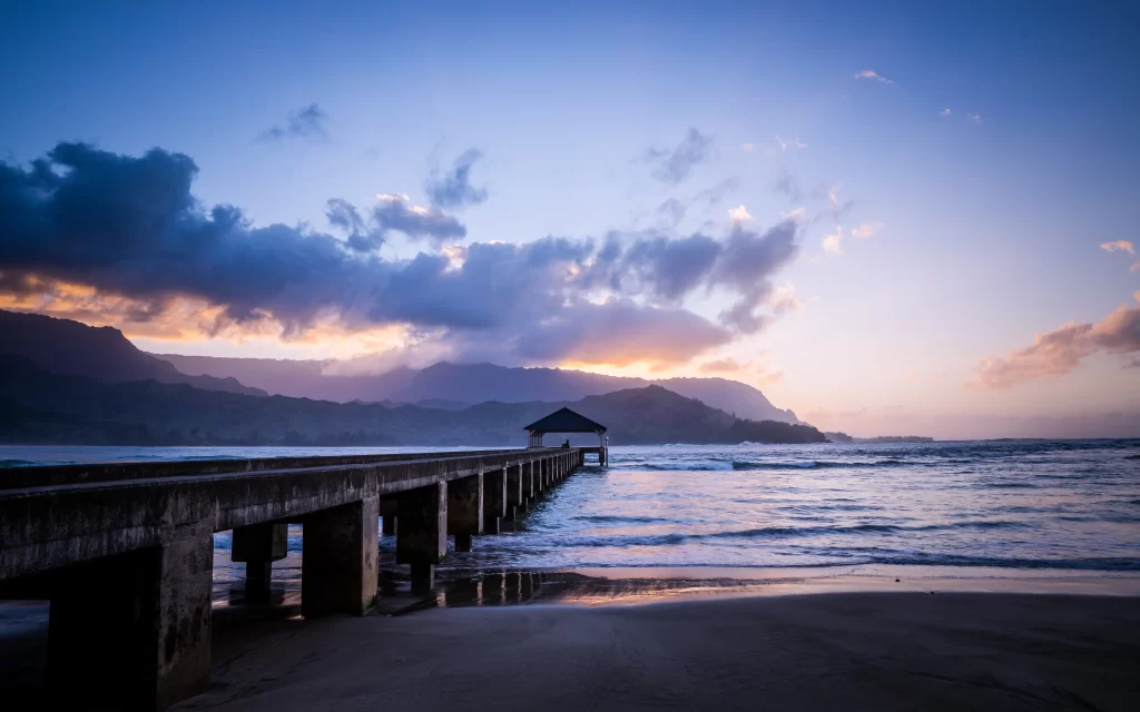 Sunset pier ocean clouds mountains beach