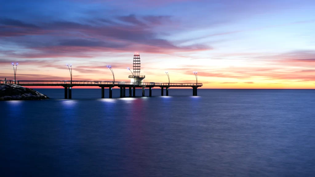 Sunset pier ocean sky clouds lights