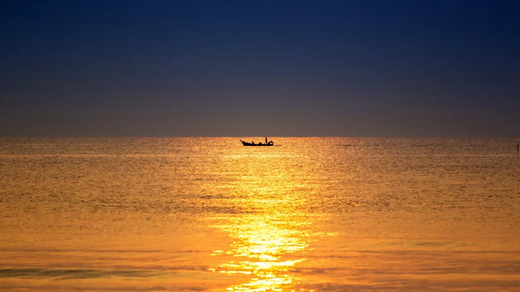 Sunset sea boat horizon reflection calm