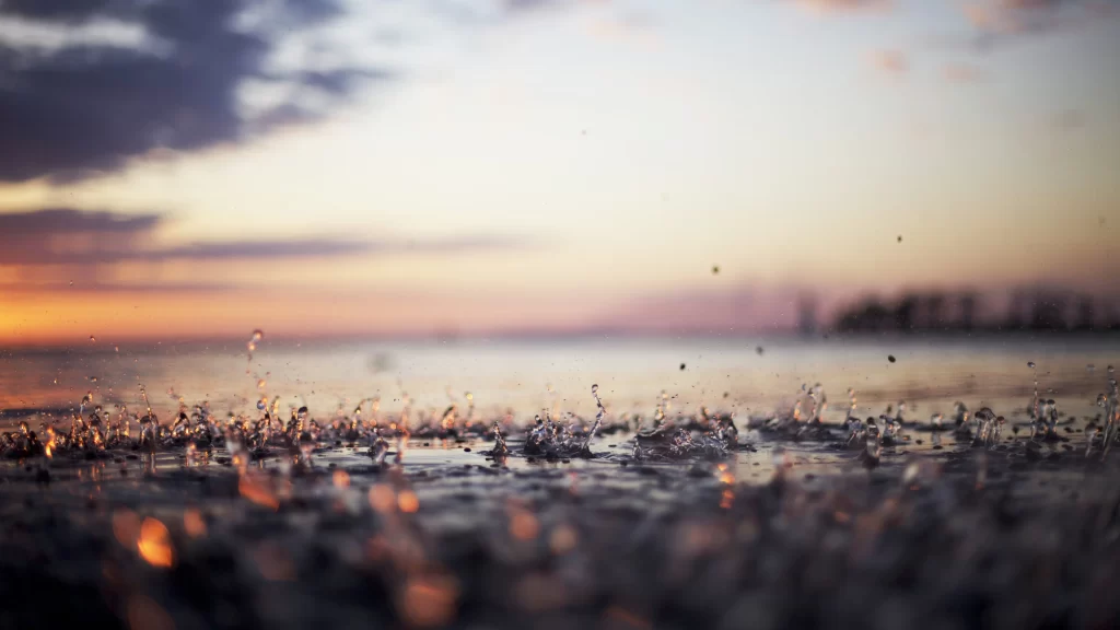 Sunset water splashes sky clouds reflection