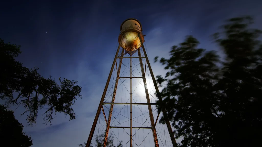 Water tower night moon trees sky light