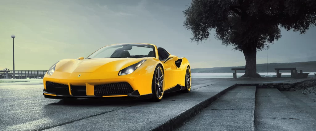 Yellow Sports Car Scenic Background Tree Bench Waterfront Cloudy Sky