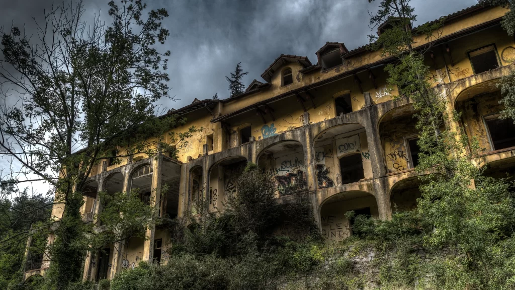 abandoned building overgrown vegetation dilapidated structure cloudy sky urban d