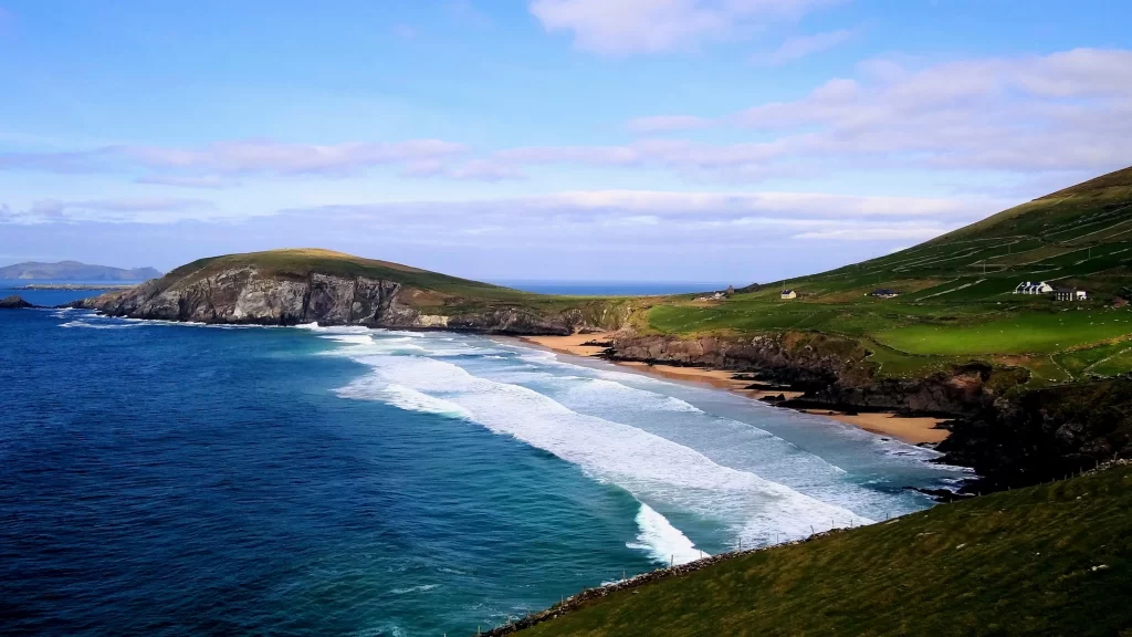 beach ocean waves cliffs grass sky clouds
