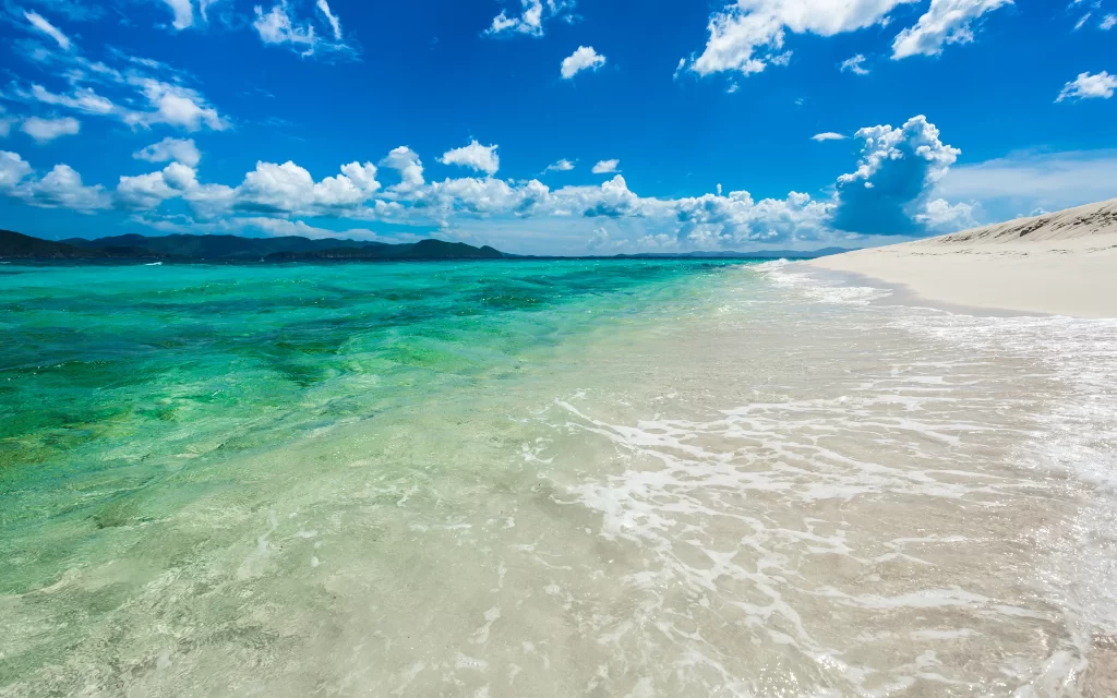 beach ocean waves sand sky clouds