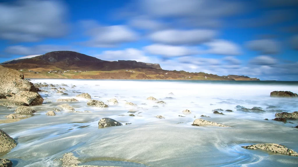 beach rocks waves sky clouds landscape
