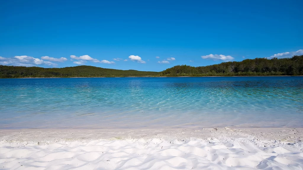 beach water sky sand clouds landscape