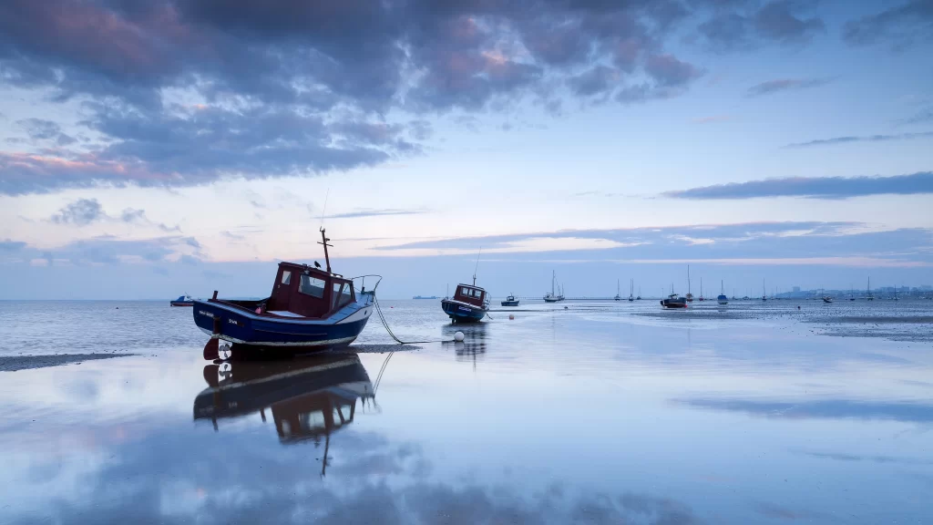 boat water reflection sky clouds sunset