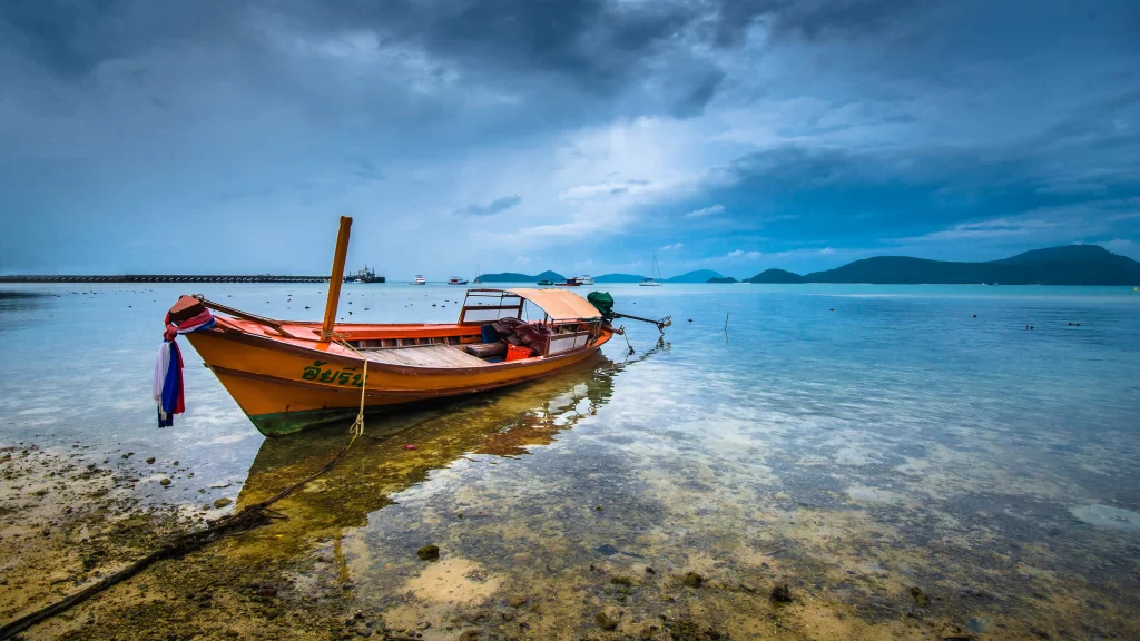 boat water sky clouds shore reflection