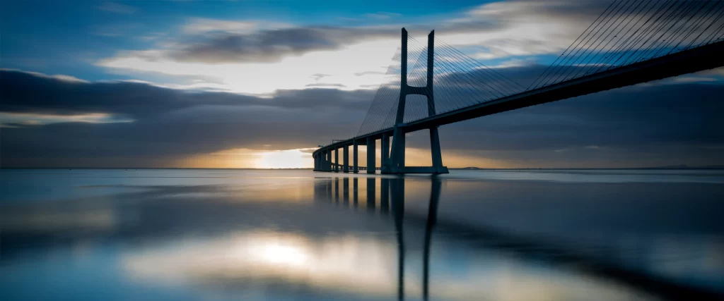 Bridge Sunset Water Reflection Clouds Serene