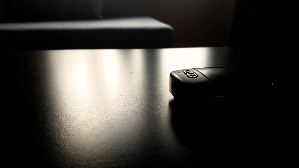 car keys table sunlight shadow brand logo Audi