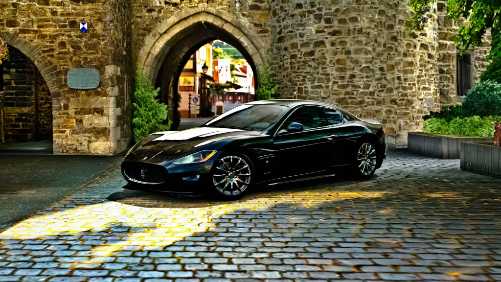 car stone archway sunlight cobblestone shadow