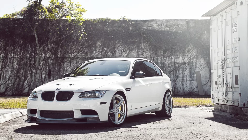 car white BMW wheels sunlight